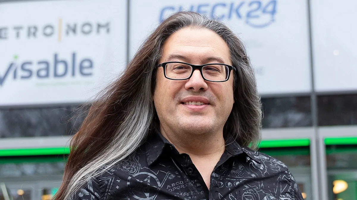Photo of John Romero in front of a building.