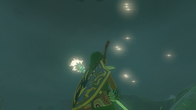 Link looking at light orbs from Magid Rod fused to Star Fragment in The Legend of Zelda: Tears of the Kingdom.