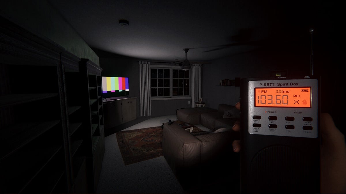 Phasmophobia: the player holding a spirit box while stood in a living room.