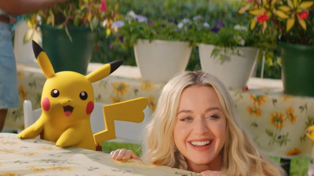 Katy Perry and Pikachu at table.