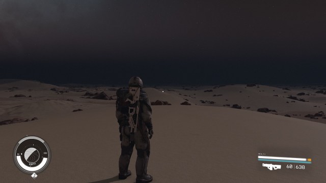 Die Starfield-Erde: Ein Astronaut stand nachts und blickte auf die öden Landstriche.