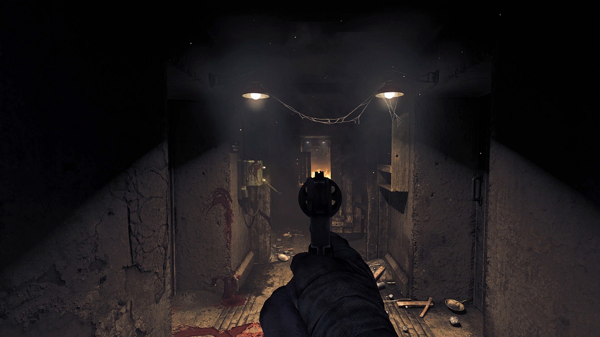 Amnesia: The Bunker: the player pointing a revolver down a dark corridor.