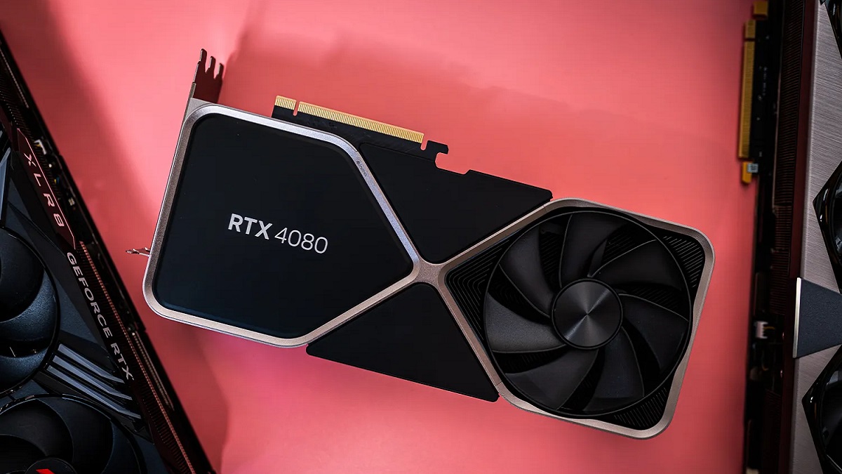 An Nvidia RTX 4080 graphics card on a salmon pink surface.