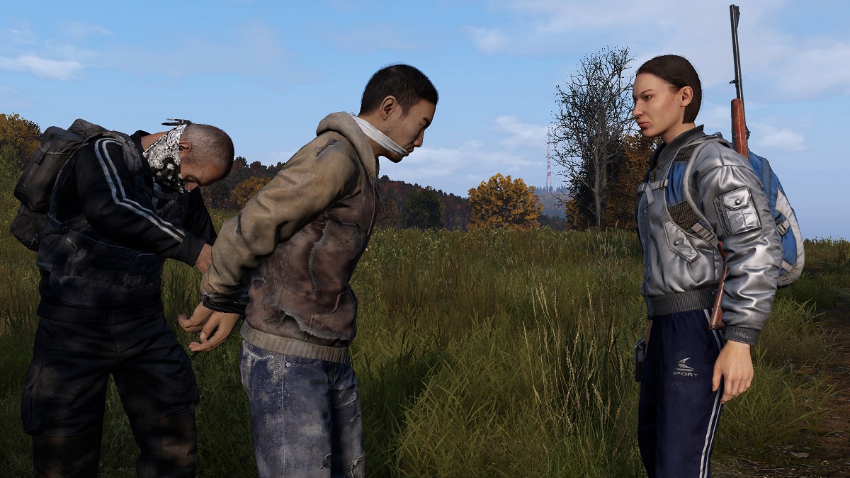 DayZ: a player is gagged and tied up by two others.