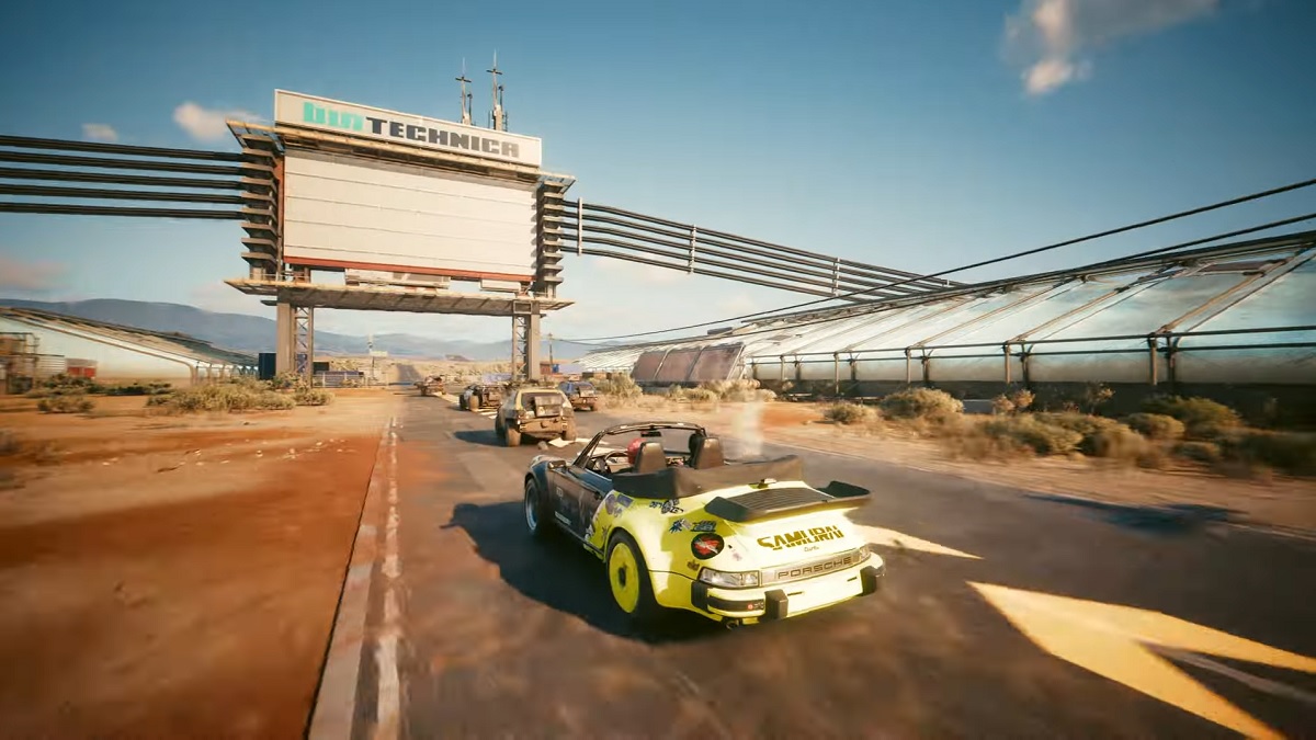 Cyberpunk 2077: cars racing each other along an industrial-looking road.
