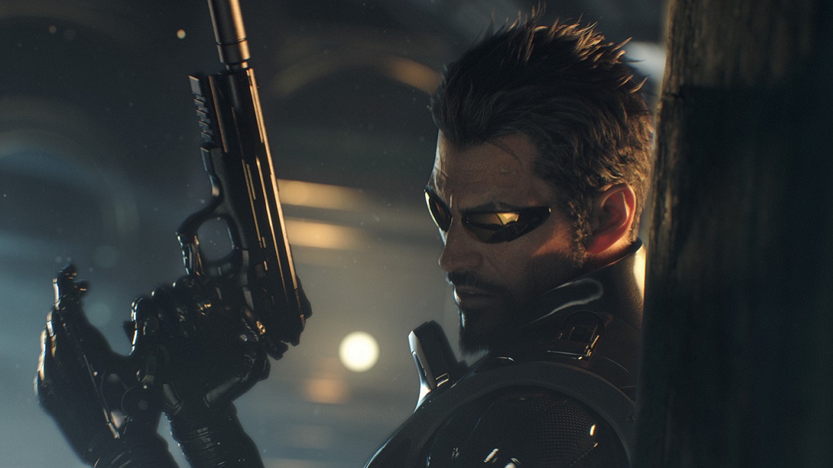 Deus Ex: Adam Jensen loading a pistol while leaning against a wall.
