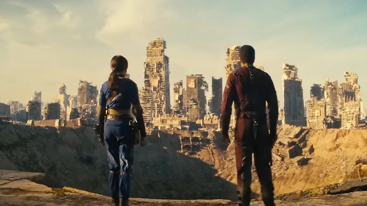 Fallout: two people stood on the outskirts of city that's dilapidated.
