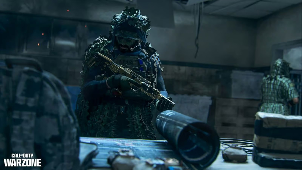 A CoD player holding an assault rifle while looking at a blueprint on a table.