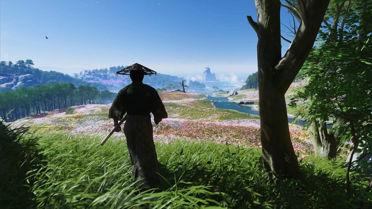 Ghost of Tsushima: Jin Sakai standing in a lush field.