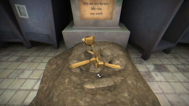 A golden metal rose sticking out of the ground, held in metal hands.