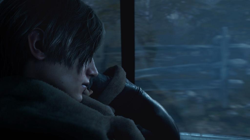 Resident Evil 4 remake: Leon Kennedy looks out the car window on a gloomy night.