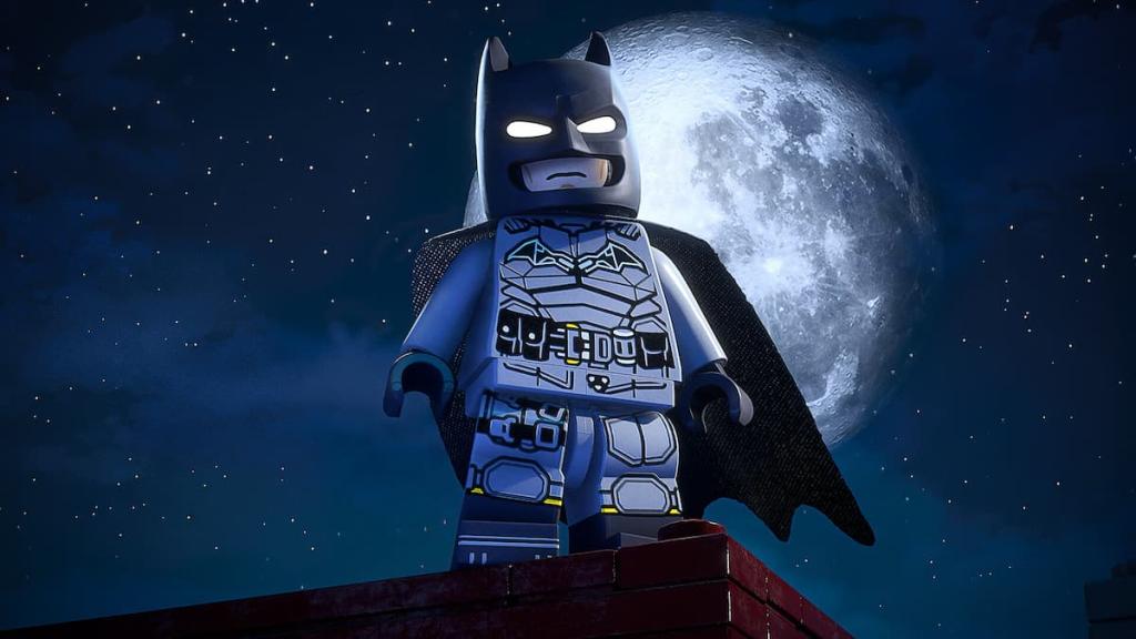 LEGO Batman menacingly standing on top of a building with a massive moon behind him in LEGO Batman: Legacy of the Dark Knight.