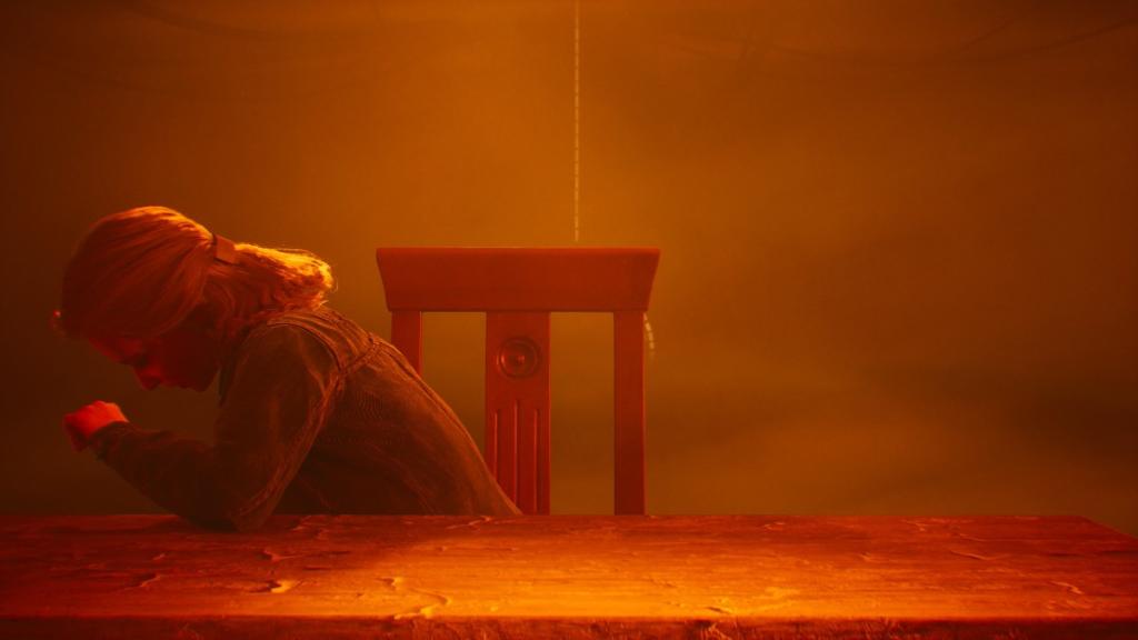 Angela inside the Ascendance Terminal, putting her head in her hand