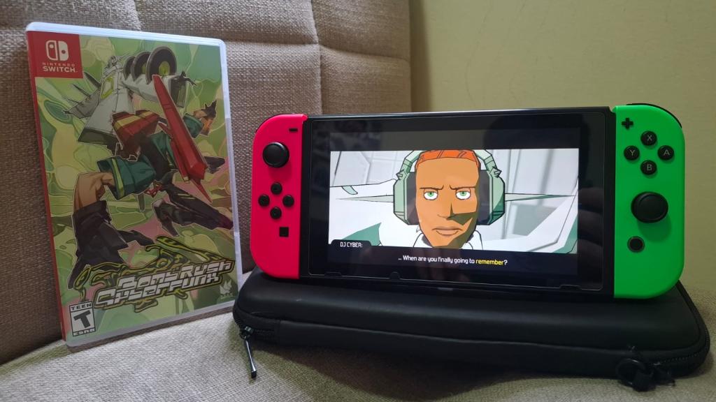 A photo of Bomb Rush Cyberfunk box next to a Nintendo Switch running the game.