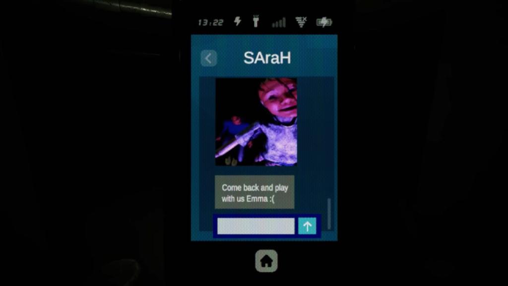 The entity wearing a smiling mask with Sarah's unmoving body behind her, inviting Emma to come back and play on Sarah's message log