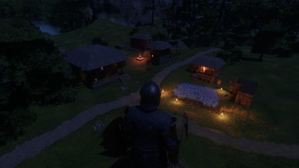 A player-built village at night in Enshrouded.