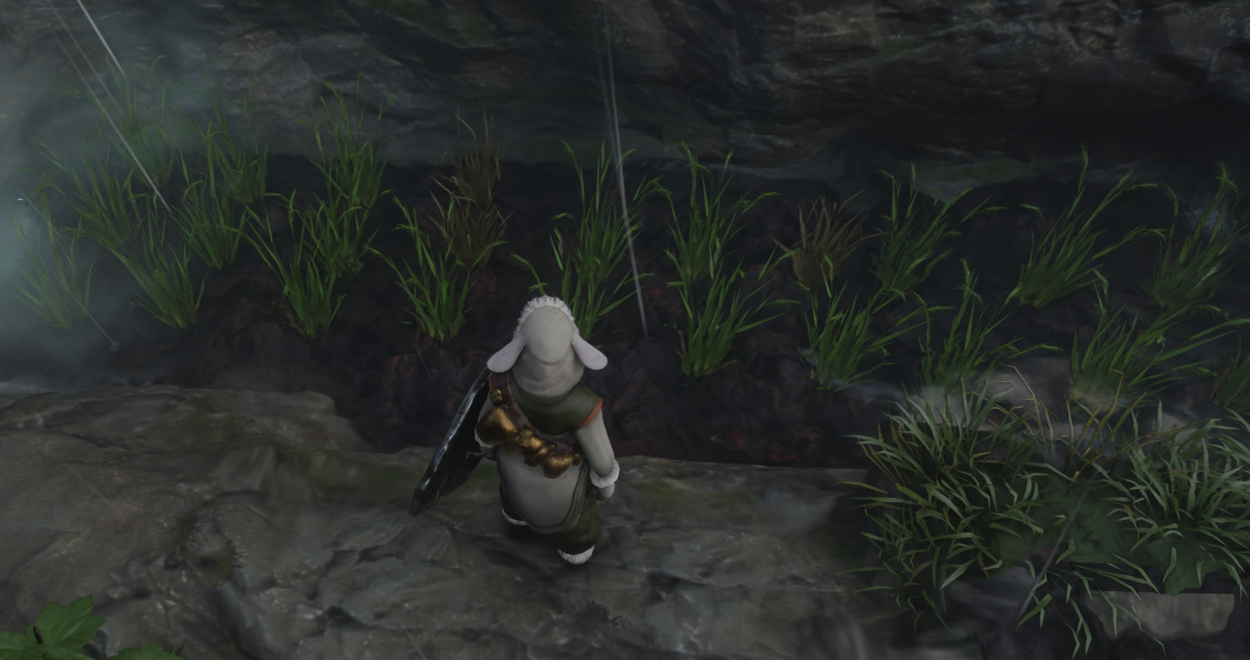 A player character in Enshrouded stands in front of a farm bed with rice seedlings in it.