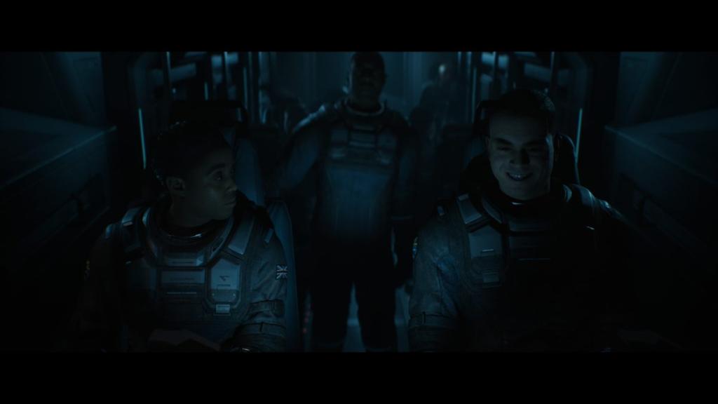 Young sitting next to a smiling Mitchell with Stafford standing in back of S.E.V.