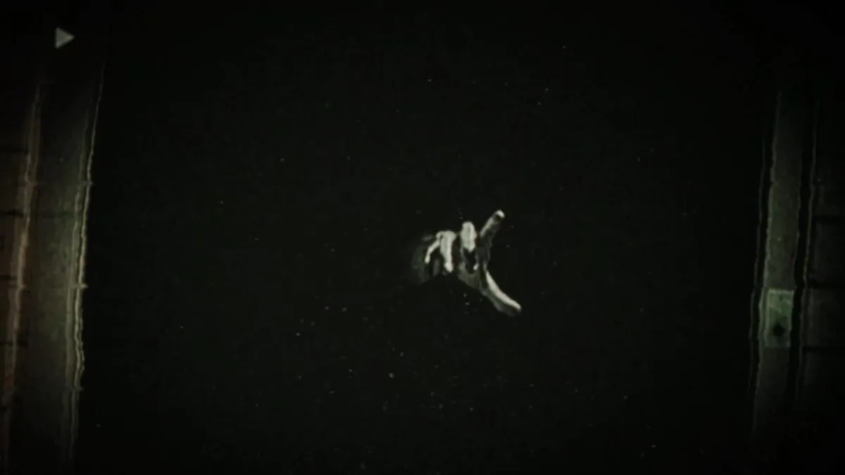 Hand poking out of the darkness