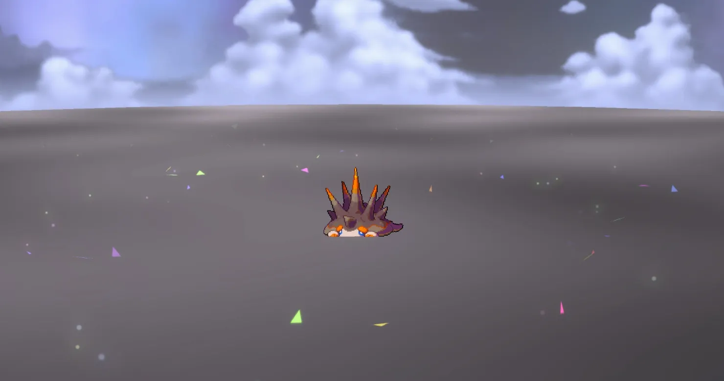 Kinedge, a tiny small spiky brown and orange creature, sits in an open plain with confetti