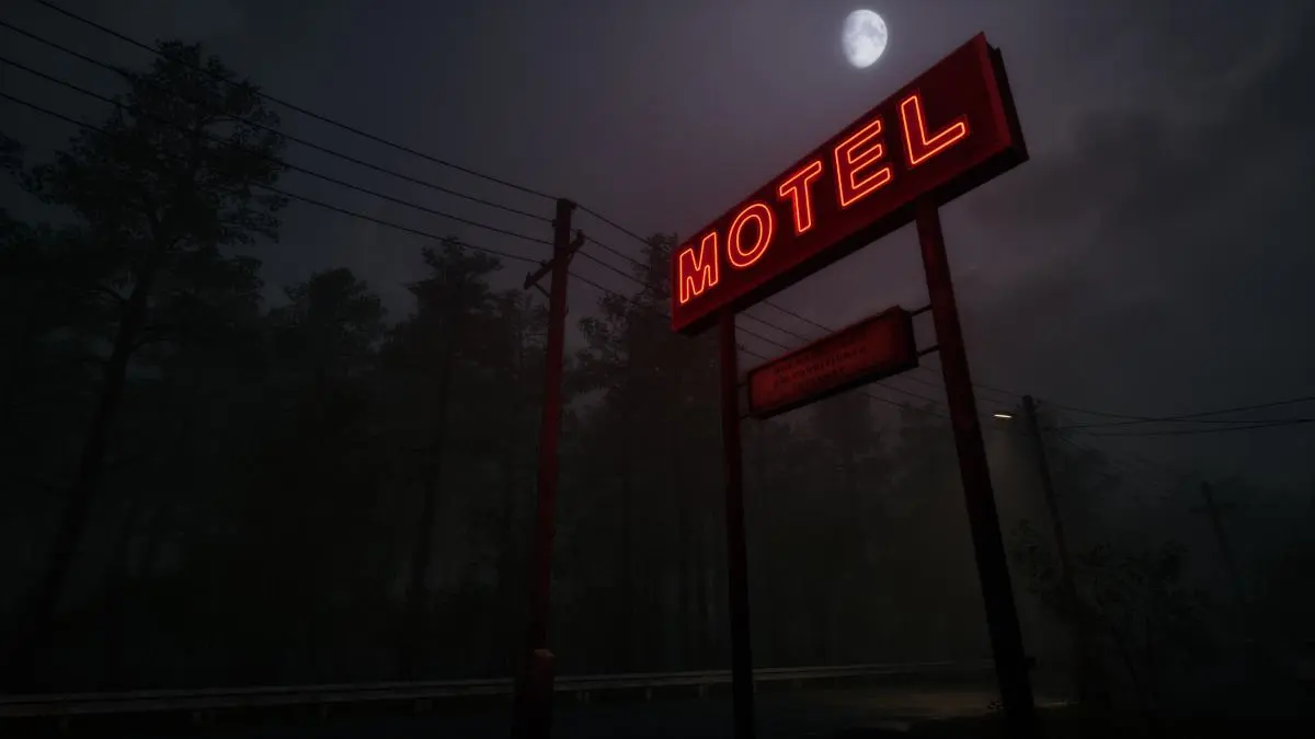 The motel sign with trees and power lines in the background
