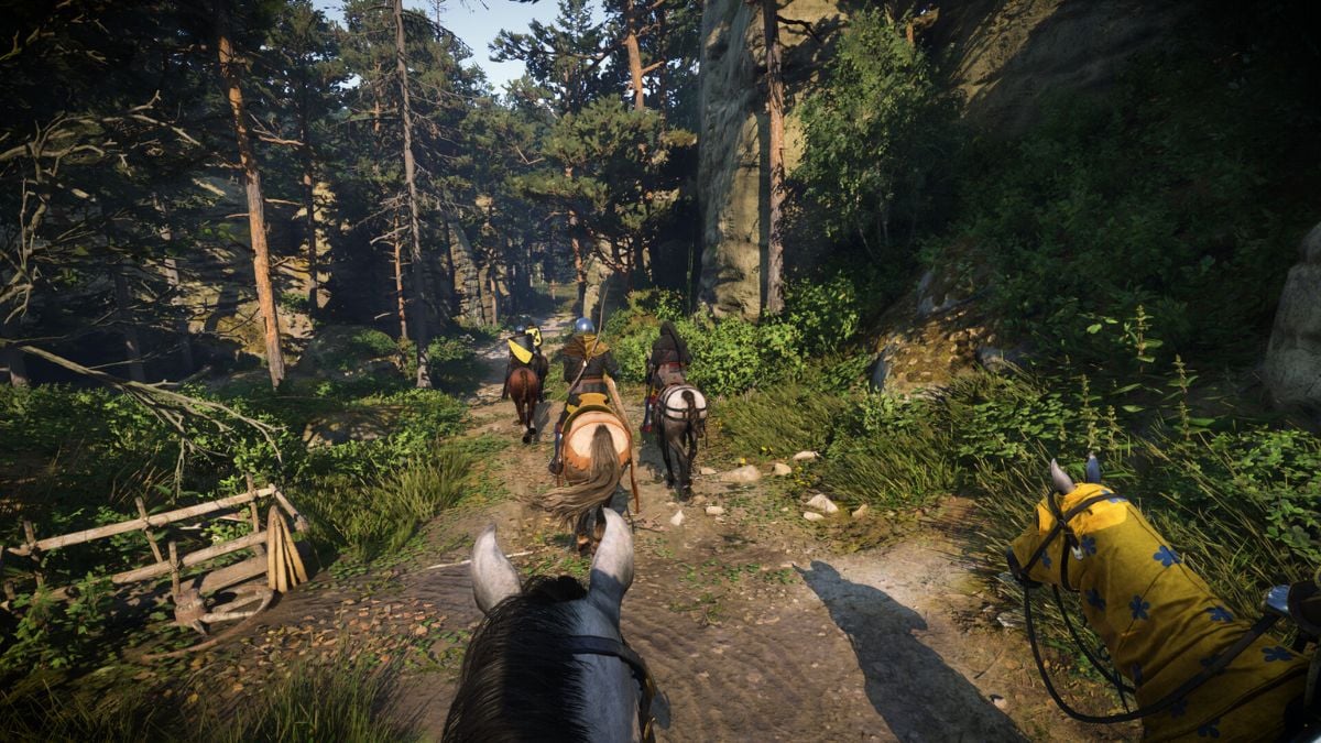 A mounted party travels through the woods in KCD 2.