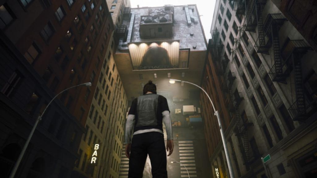 Dylan Faden stands in front of an inverted wall in CONTROL Resonant. The wall is coming off the ground, like a road was split in half and pasted vertically.