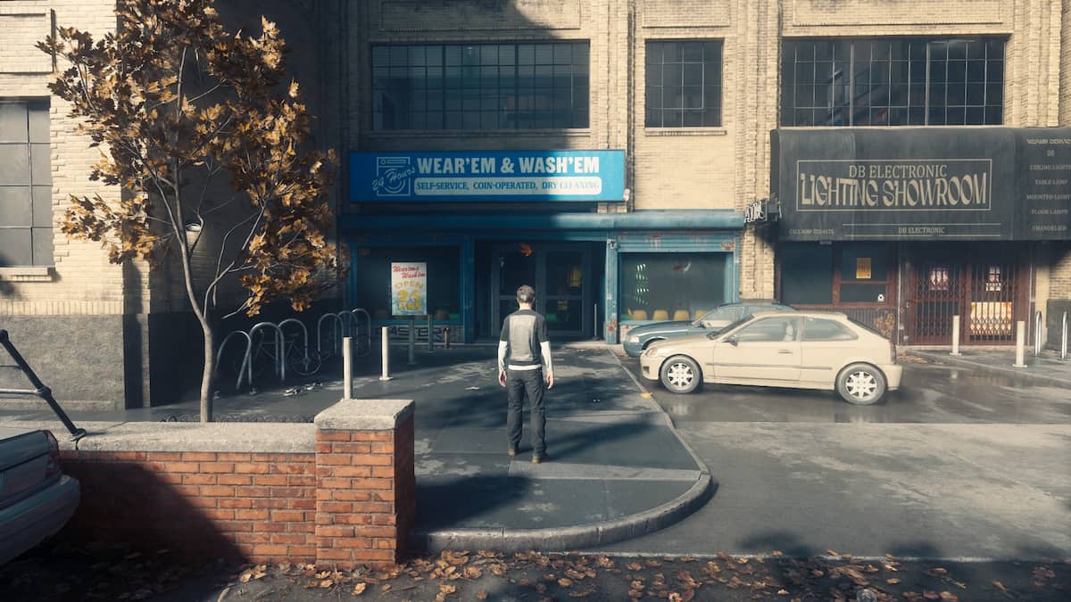 Dylan stands in front of the Wash 'Em Wear 'Em laundry in Central in CONTROL Resonant.