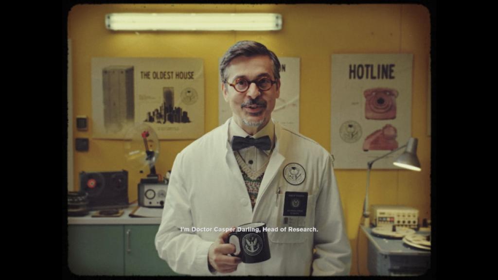 Dr. Casper Darling, a middle-aged man with round glasses, a goatee, a labcoat, and a coffee mug in hand, appears in CONTROL.